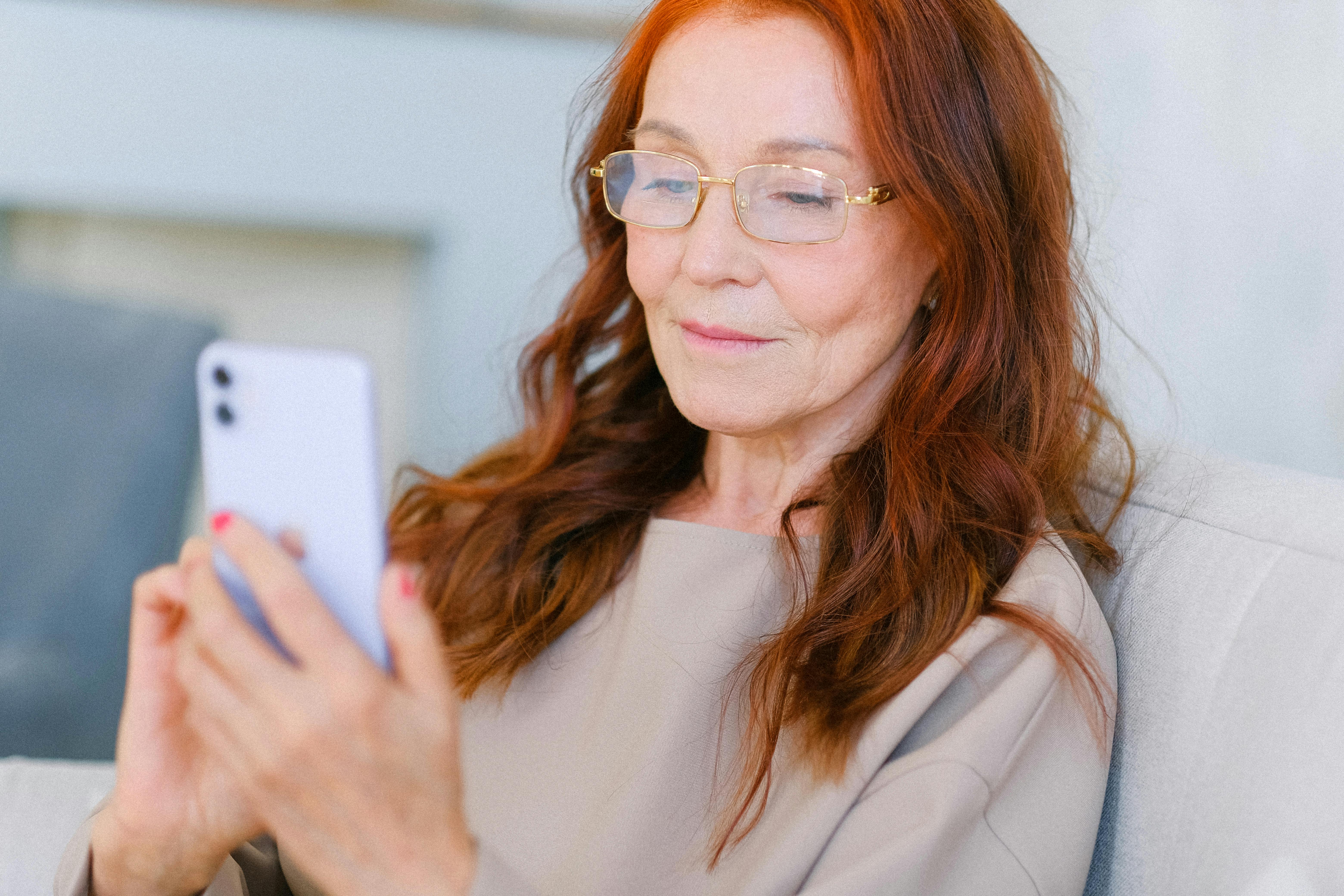 An elegant older woman browsing on her phone